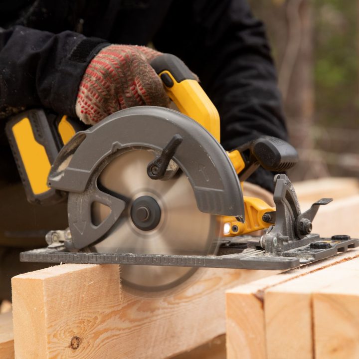 Builder,Uses,Portable,Circular,Saw,Tool,To,Cut,Wood.