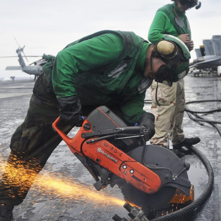 100922-N-7103C-091 
PACIFIC OCEAN (Sept. 22, 2010) Aviation BoatswainÕs Mate 3rd Class Max Torres, from Houston, uses a chop saw to cut through a worn arresting cable in preparation for the installation of a new one aboard the aircraft carrier USS George Washington (CVN 73). George Washington, the NavyÕs only permanently forward-deployed aircraft carrier is underway helping to ensure security and stability in the western Pacific Ocean. (U.S. Navy photo by Mass Communication Specialist 3rd Class David A. Cox/Released)