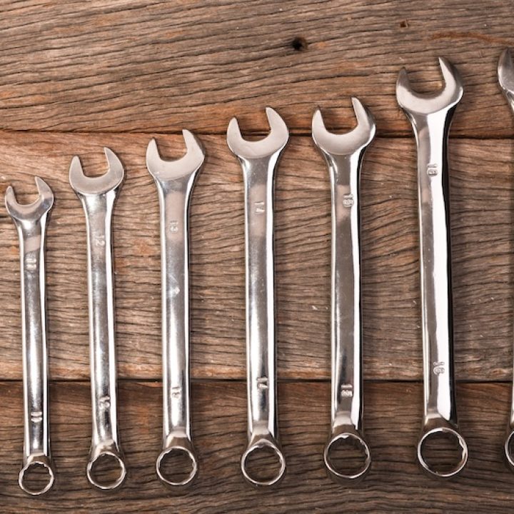 wrenches on wooden background